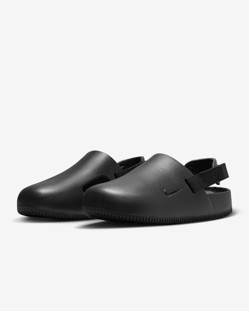 Nike Calm Mule shoes in black with slip-on design, back strap, and textured outsole, front angle view.