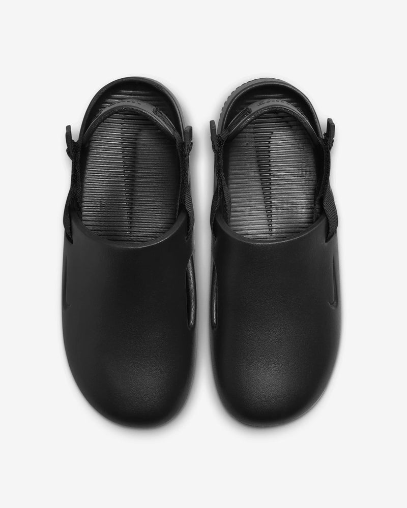 Nike Calm Mule slip-on shoes in black with a sleek synthetic upper and structured footbed, top view.