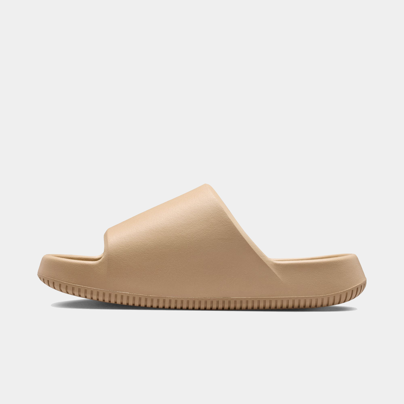 Nike Calm Slide 2.0 slides in beige with a minimalist design and textured outsole, side view.