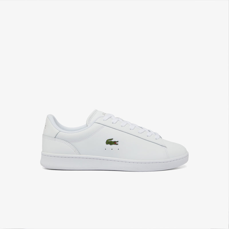 Lacoste Carnaby Set Leather Sneakers in white with embossed Lacoste crocodile logo on the side and perforation details, side view.