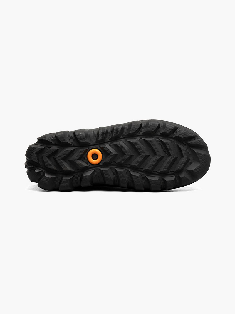 Black Bogs boot sole with orange logo white background