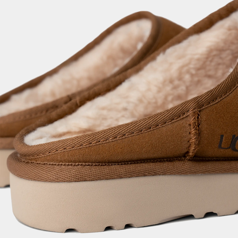 UGG Classic Slip-On shoes in chestnut brown suede with soft shearling interior and lightweight beige sole, close-up side angle.