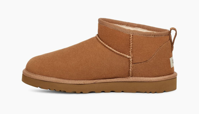 UGG Classic Ultra Mini Boot in chestnut brown suede with plush shearling lining and durable treaded outsole, side view.