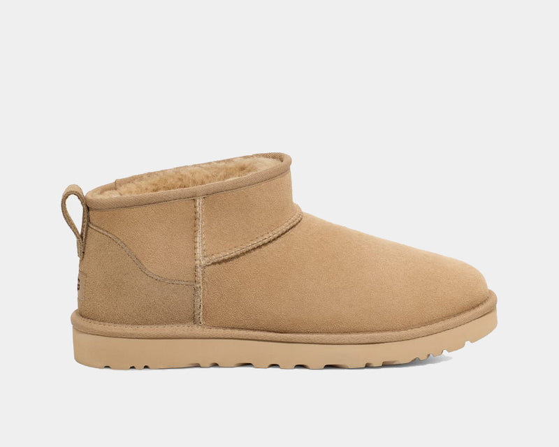 UGG Classic Ultra Mini Boot in chestnut brown suede with low shaft design and plush shearling lining, side view.