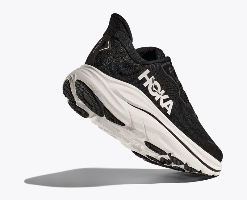 HOKA Clifton 10 running shoes in black with breathable mesh upper and cushioned white midsole, angled side-bottom view.
