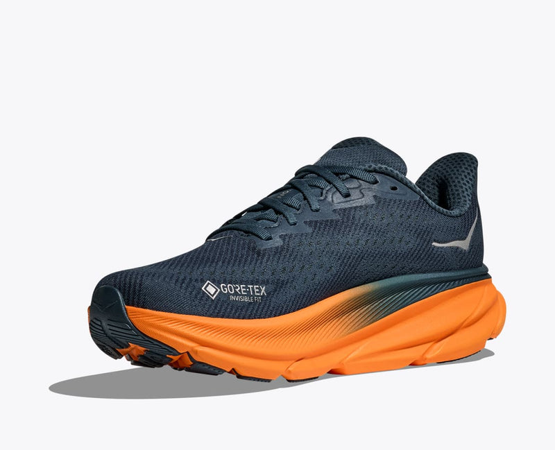 HOKA Clifton 9 GTX running shoes in dark navy with a waterproof GORE-TEX upper and vibrant orange midsole, angled front side view.