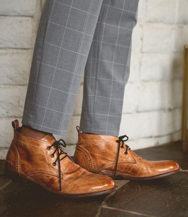 Bed Stu Clyde Chukka leather boots in warm tan with a distressed finish, lace-up closure, and round toe, shown in lifestyle context.