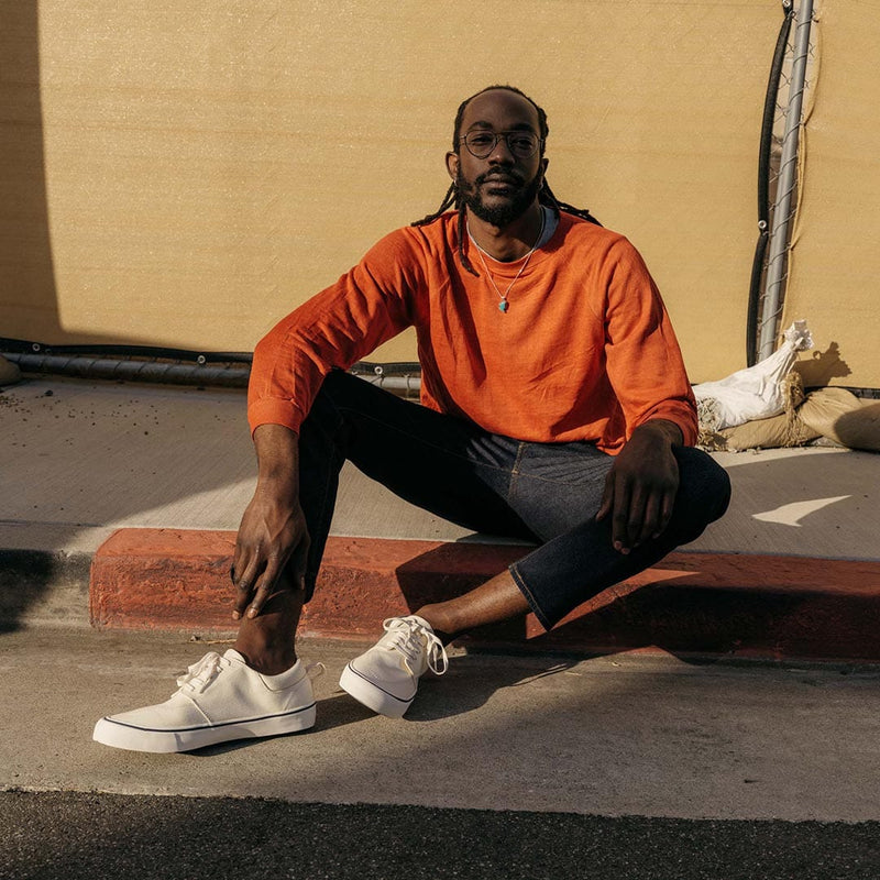 SeaVees Coastal Cruiser shoes in off-white canvas with lace-up design, worn outdoors on pavement.