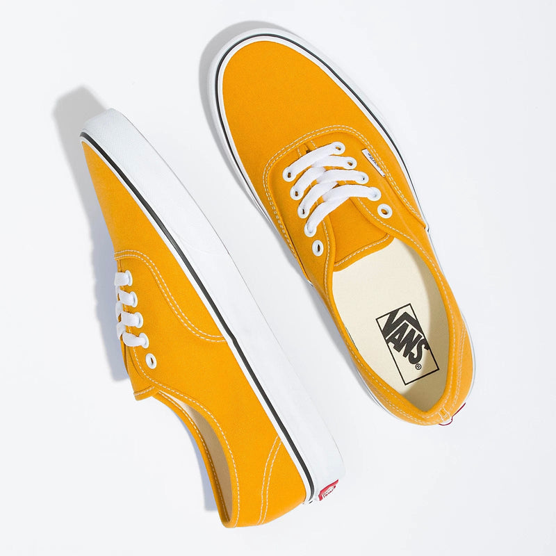 Vans Color Theory Authentic sneakers in vibrant orange canvas with white stitching, laces, and rubber outsoles, top angled view.