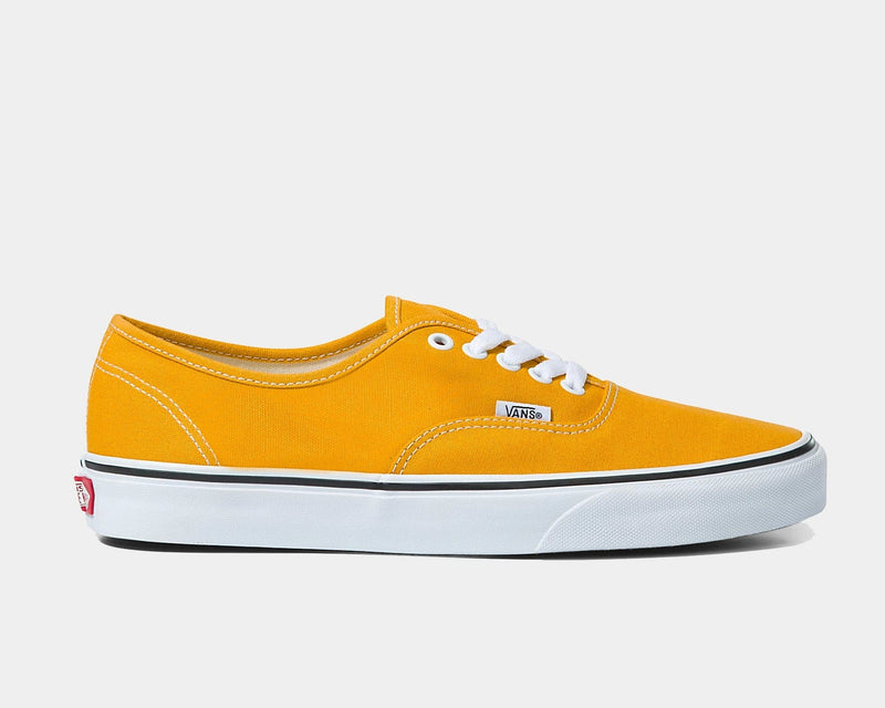 Vans Color Theory Authentic sneakers in bright yellow canvas with white laces, metal eyelets, and vulcanized white sole, side view.
