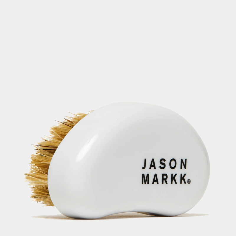 Jason Markk Complete Clean Kit cleaning brush with white ergonomic handle and natural bristle design, side view.