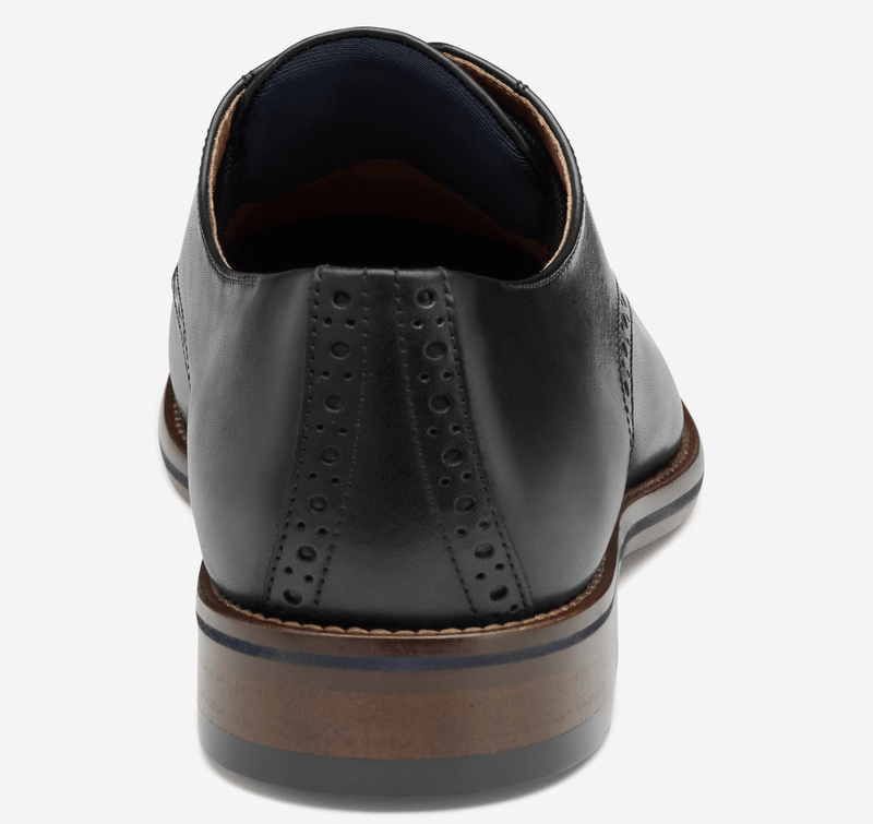 Johnston & Murphy Conard 2.0 Plain Toe dress shoes in black leather, back view showcasing brogue detailing and stacked heel.