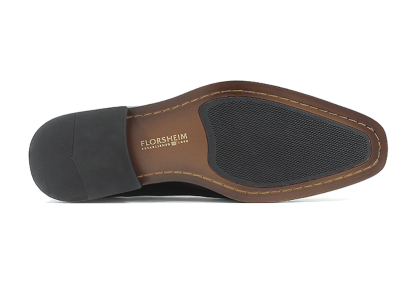 Florsheim Corbetta dress shoe sole view showcasing brown leather outsole with black rubber grip inserts and stitched detailing.