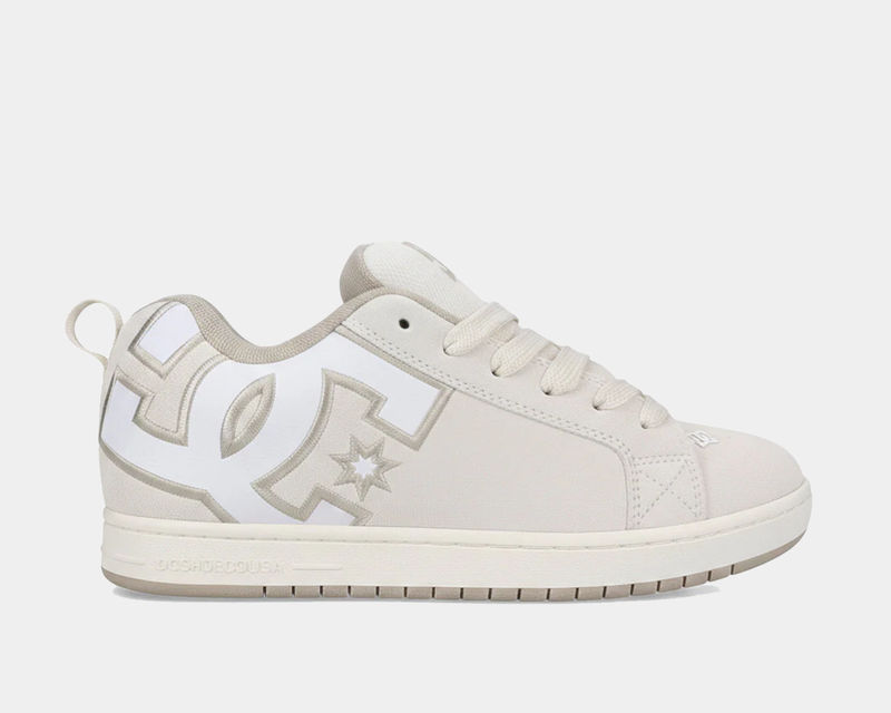 DC Footwear Court Graffik SE skate shoes in light beige with oversized white logo detailing, suede upper, and padded collar, side view.