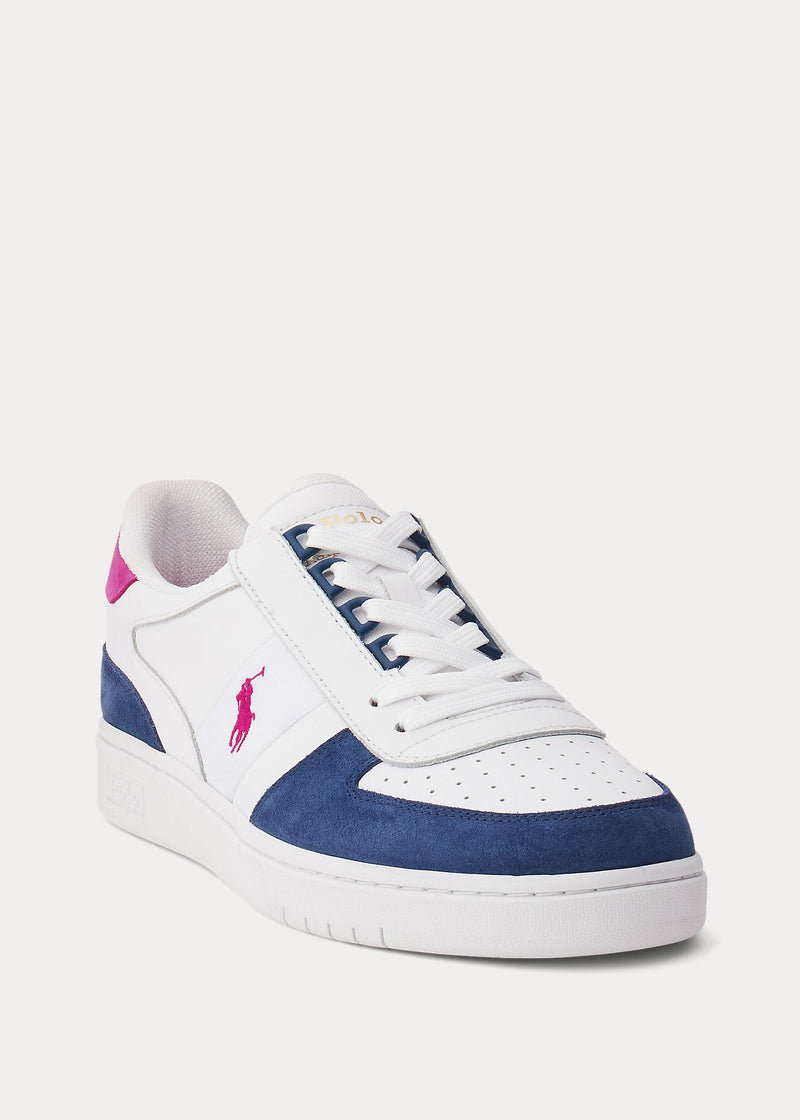 Polo Ralph Lauren Court PP shoes in white leather with navy blue suede overlays, pink logo detailing, and perforated toe box, angled front view.