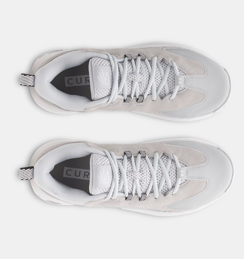 Under Armour Curry 3Z 25 SDE basketball shoes in light gray and white featuring suede overlays, mesh tongue, and striped pull tab, top view.