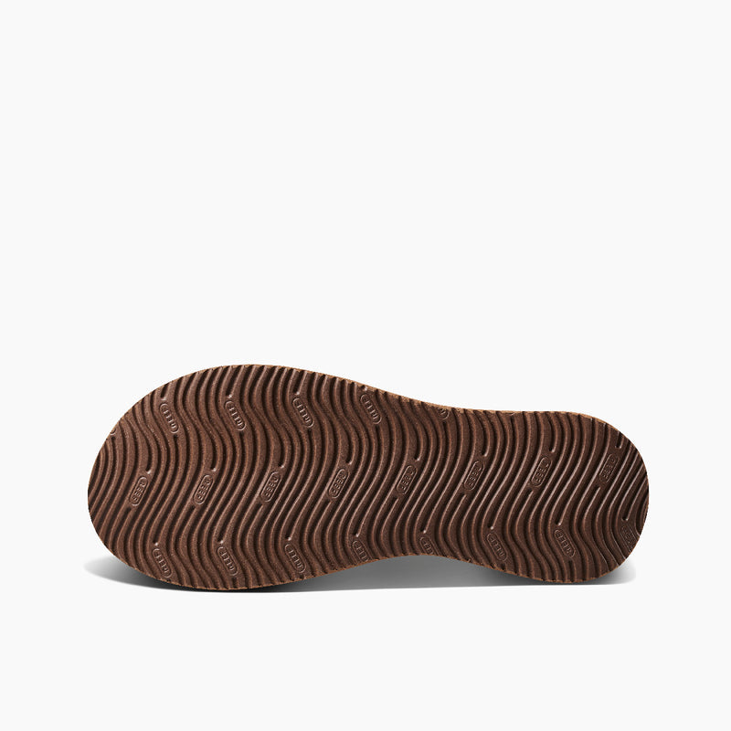 Reef Cushion Phantom 2.0 LE sandal outsole in brown showing wave-pattern tread for traction and durability.