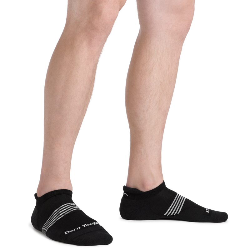 Darn Tough Element No Show Tab Lightweight Running Sock in black with white stripe accents, worn by model showing side view.