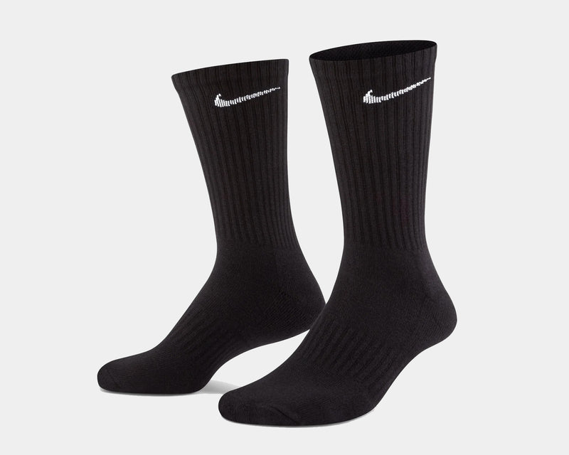 Nike Everyday Cushioned Crew Socks in black with ribbed cuffs and white Nike swoosh logo, angled side view.