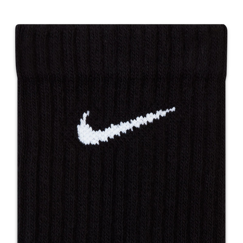 Nike Everyday Cushioned Crew Socks in black with ribbed texture and white swoosh logo, close-up view.