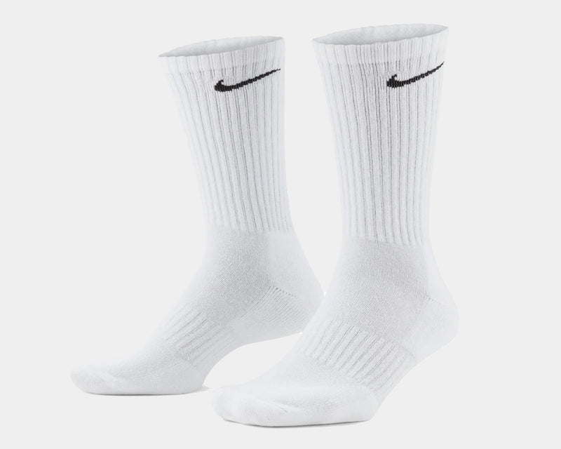 Nike Everyday Cushioned Crew Socks in white with ribbed cuffs and black swoosh logo, front angled view.