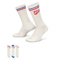 Nike Everyday Plus Crew Socks in white with red and blue accents, ribbed cuffs, and arch support, angled side view.