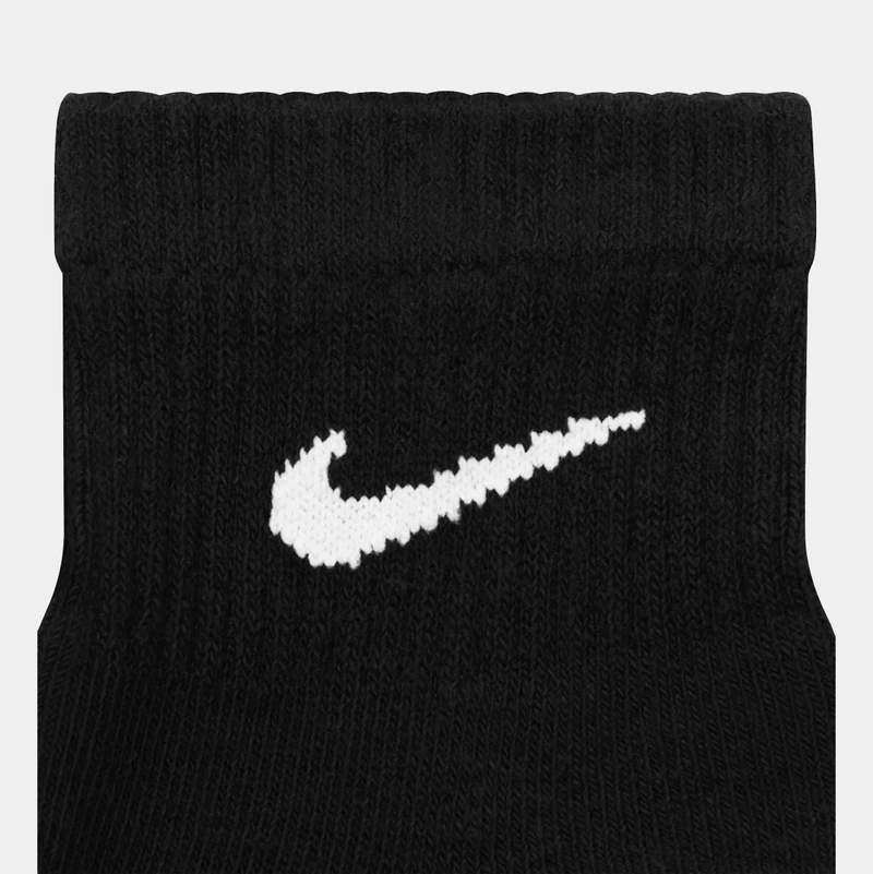 Nike Everyday Plus Cushioned Ankle Socks in black with white embroidered Swoosh logo, close-up view of cuff and knit fabric.