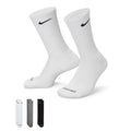 Nike Everyday Plus Cushioned Training Crew Socks in white with black Swoosh logo, ribbed cuffs, and Dri-FIT technology, side angle.