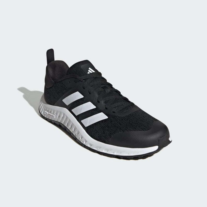 Adidas Everyset Trainer shoes in black with white accents, mesh upper, and textured midsole, front angled view.