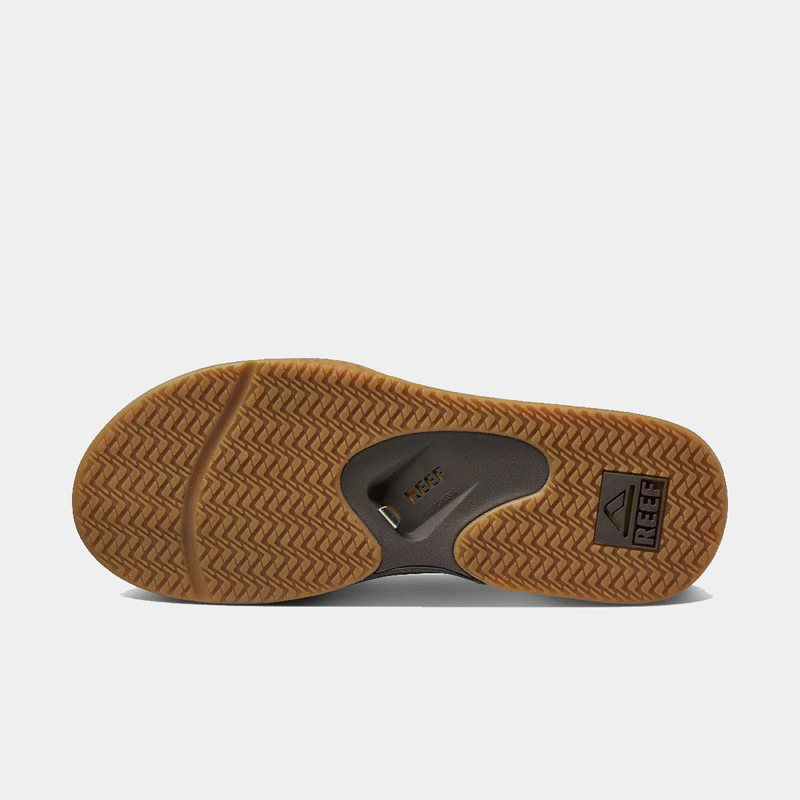 Reef Fanning Flip Flops outsole with bottle opener feature, herringbone tread pattern, and brown rubber material.
