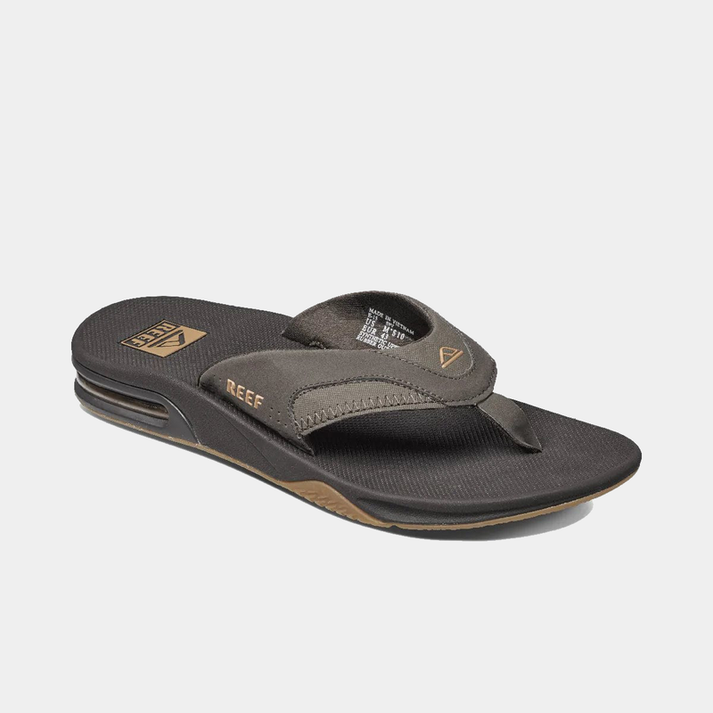 Reef Fanning Flip Flops in brown with synthetic strap, cushioned footbed, and bottle opener feature, angled side view.
