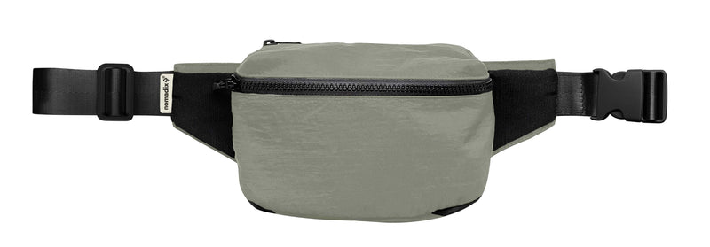 Nomadix Fanny Pack in olive green with black adjustable strap, zippered main compartment, and durable material, front view.