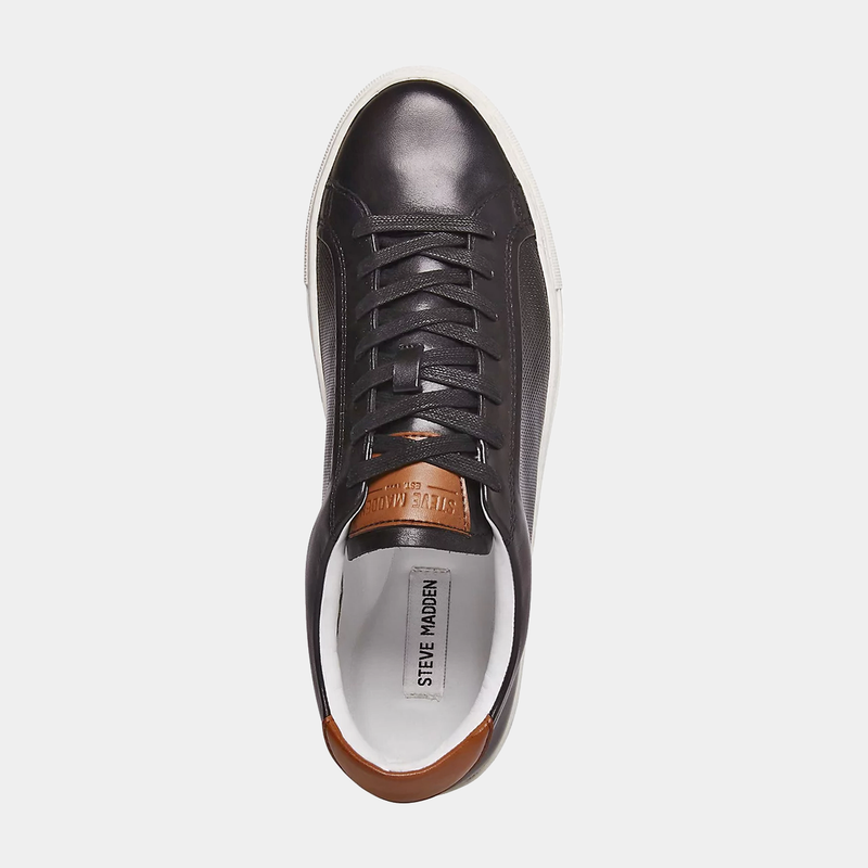 Steve Madden Finneas sneakers top view showing black leather upper, white sole, lace-up design, and brown heel accent.