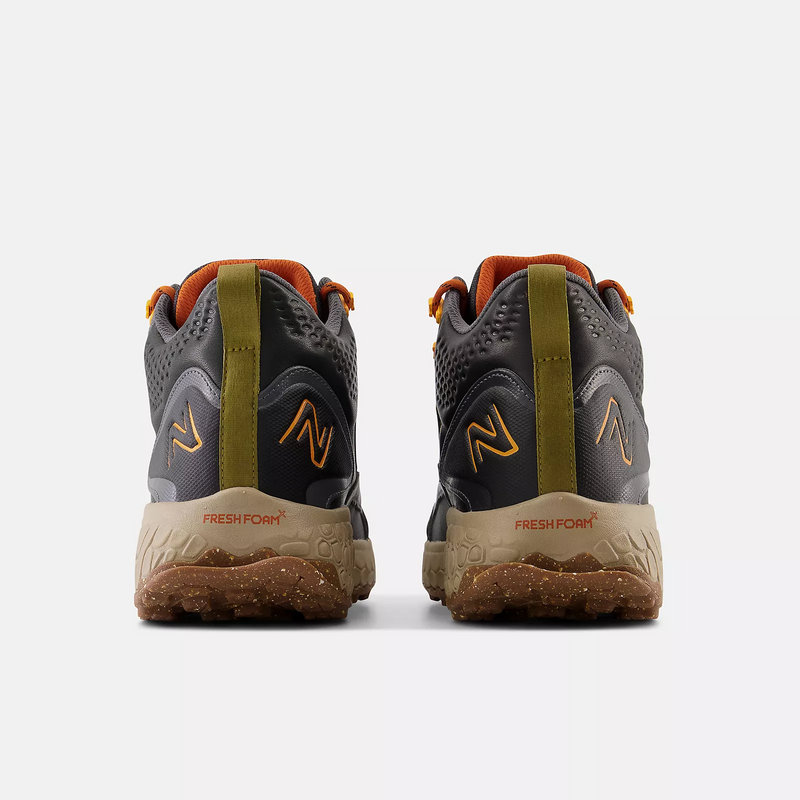 New Balance Foam X Hierro Mid GTX hiking shoes back view in gray and orange with Fresh Foam midsole and textured outsole.