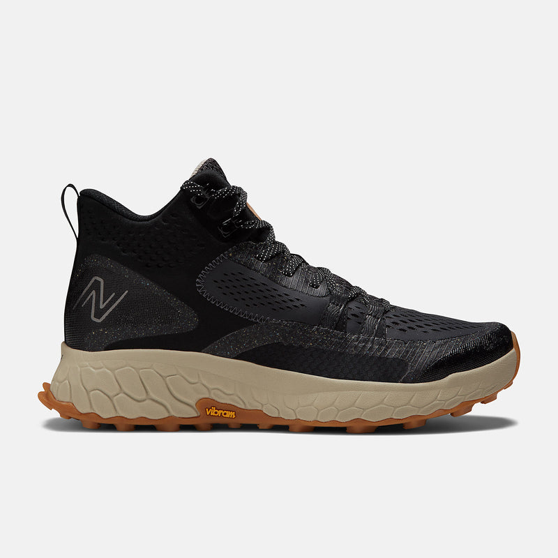 New Balance Foam X Hierro Mid GTX hiking boots in black with Gore-Tex upper, beige foam midsole, and Vibram outsole, side view.