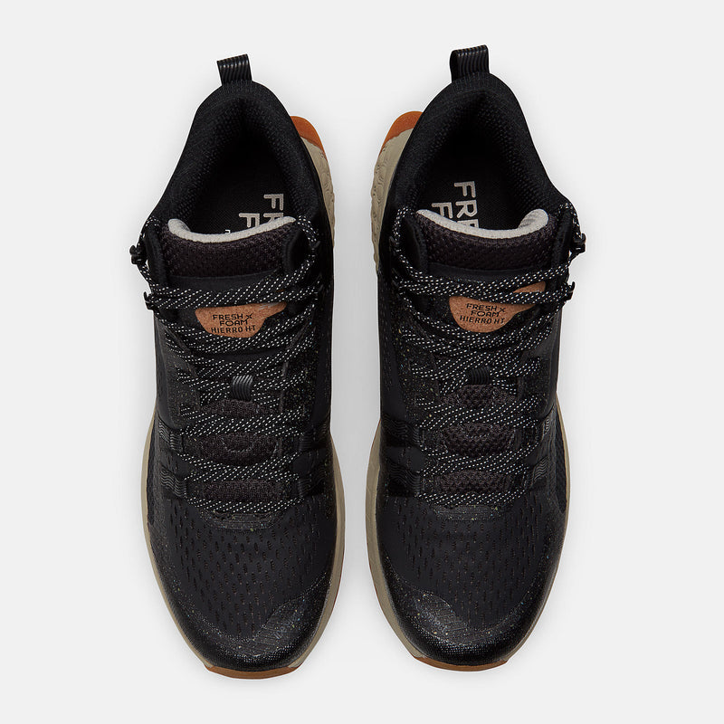 New Balance Foam X Hierro Mid GTX trail shoes in black with perforated mesh upper, lace system, and orange accents, top view.