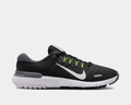 Nike Free Golf Next Nature golf shoes in black with mesh upper, white sole, neon green lace accents, and side Swoosh logo, side view.