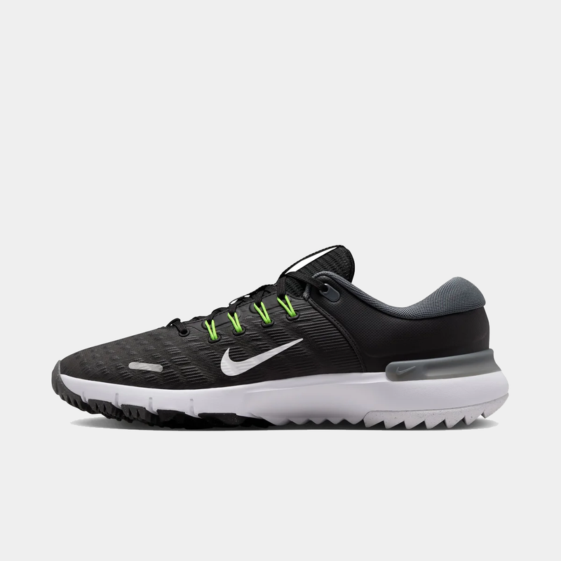 Nike Free Golf Next Nature golf shoes in black with a white sole, green eyelets, and a textured mesh upper, side view.