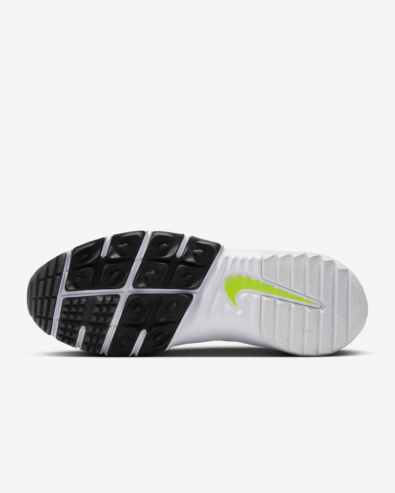 Nike Free Golf Next Nature golf shoes sole view showing black and white grooved outsole with lime green Nike Swoosh logo.