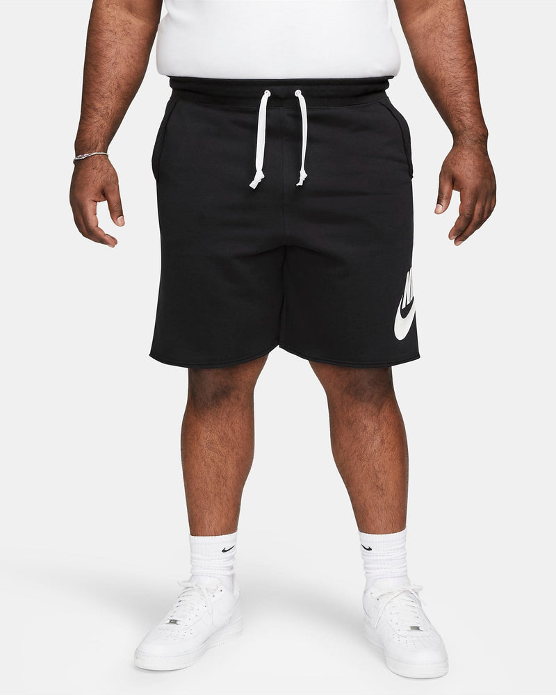 Nike French Terry Alumni Shorts in black with a white Nike logo on the left leg, adjustable drawstring waistband, front view.