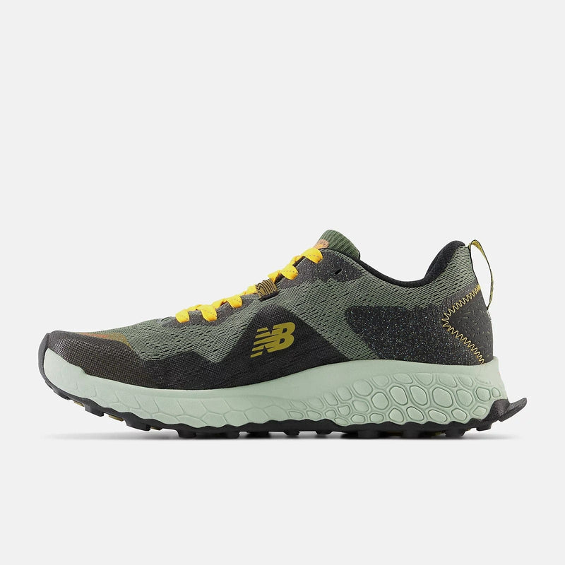 New Balance Fresh Foam Hierro v7 trail-running shoes in green and black with yellow accents and rugged outsole, side view.