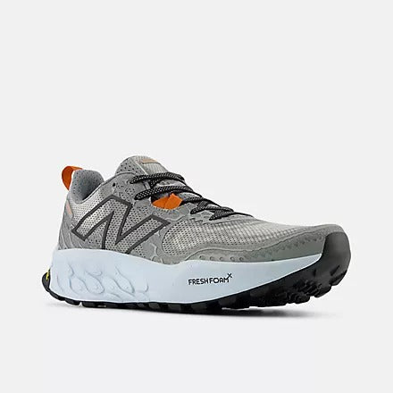 New Balance Fresh Foam Hierro v8 trail running shoes in gray with mesh upper, orange accents, and durable Fresh Foam midsole, side view.