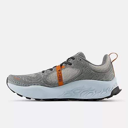 New Balance Fresh Foam Hierro v8 trail running shoes in gray with an orange strap accent and cushioned light blue midsole, side view.