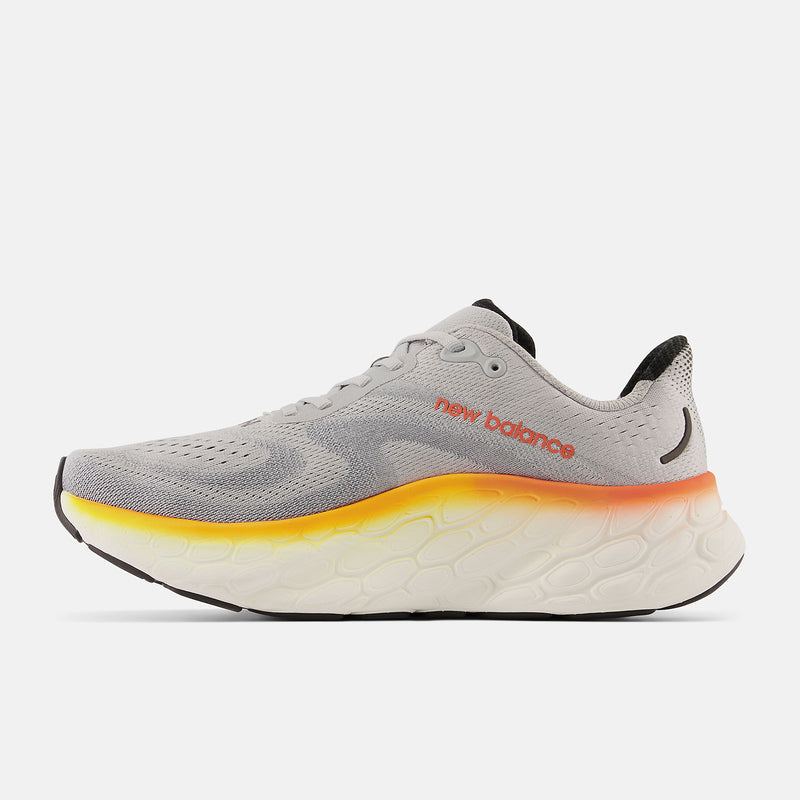 New Balance Fresh Foam More v4 running shoes in light gray with a breathable mesh upper, gradient orange-to-yellow midsole, and cushioned sole, side view.