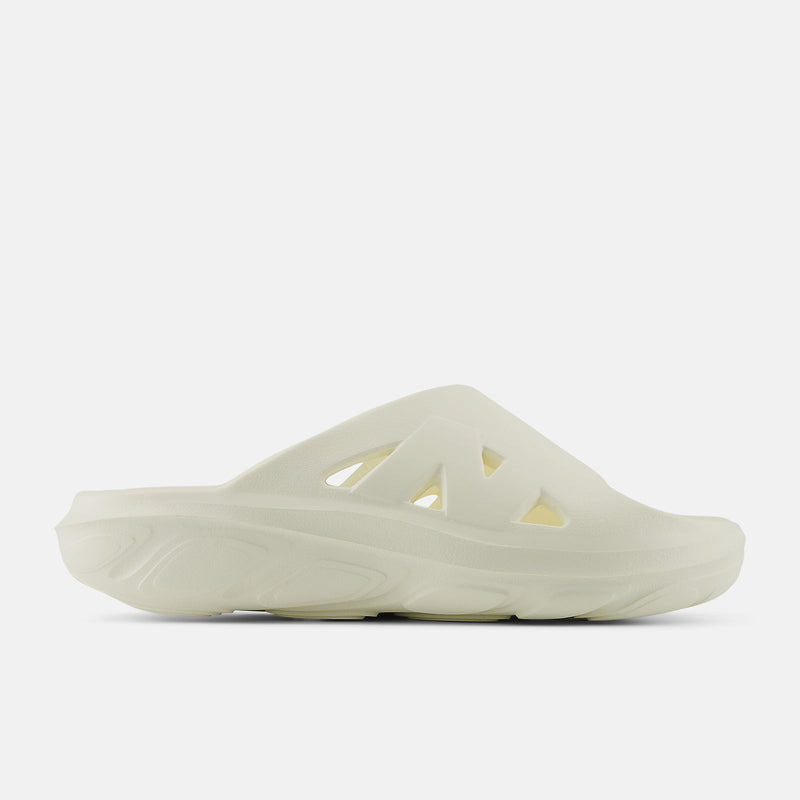 New Balance Fresh Foam RCVRY Slide sandals in cream color with foam midsole and perforated upper, side view.