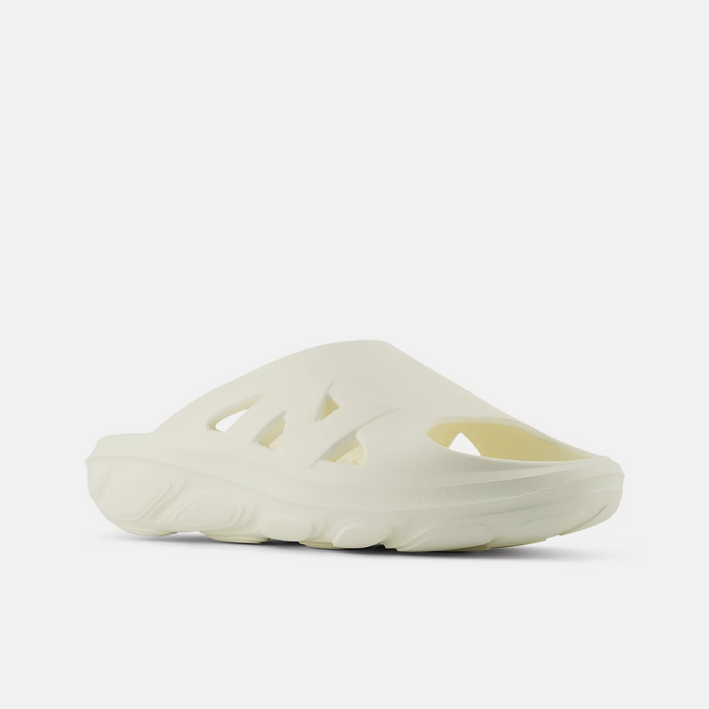 New Balance Fresh Foam RCVRY Slide sandals in off-white with soft foam midsole, cutout details, and textured outsole, angled side view.