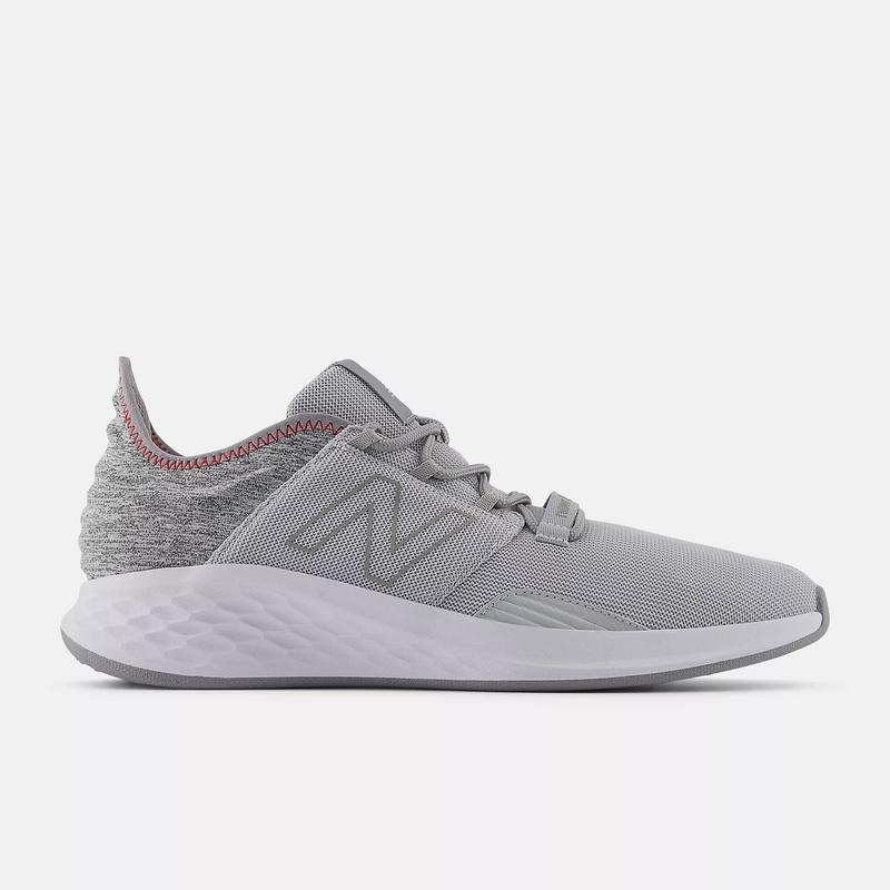 New Balance Golf Fresh Foam ROAV Golf shoes, side view in gray with knit upper, cushioned midsole, and red stitch accents.