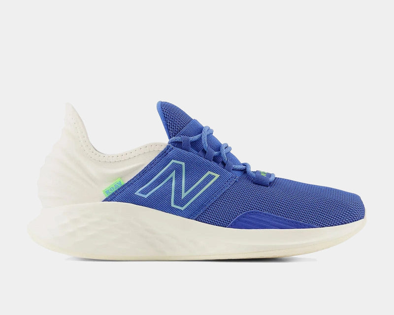 New Balance Fresh Foam Roav running shoes in blue with white midsole, mesh upper, and neon green accents, side view.