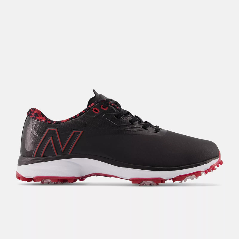 New Balance Golf Fresh Foam X Defender golf shoes in black with red accents, featuring a spikeless outsole and breathable design, side view.