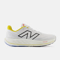 New Balance Fresh Foam X Vongo v6 running shoes in white with yellow accents, breathable mesh upper, and cushioned midsole, side view.